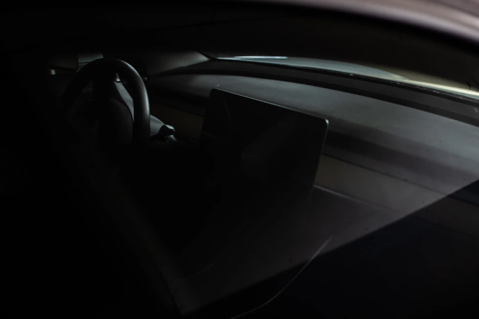 A sleek car dashboard featuring Vigilodrive's AI-powered safety monitor glowing softly.