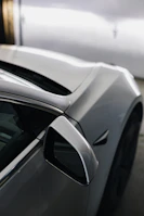 A sleek automobile shot highlighting the curves and shine of a luxury car.