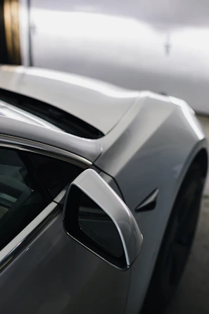 A sleek automobile shot highlighting the curves and shine of a luxury car.