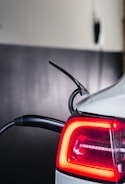 the tail light of a white car with a red brake light