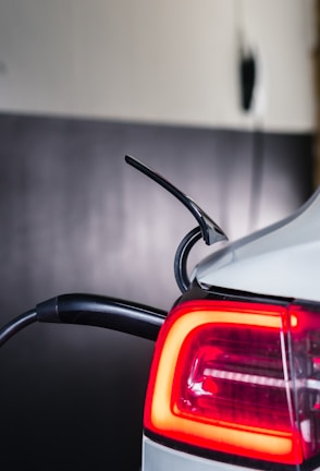 A close-up of a charging electric luxury car, highlighting the eco-friendly aspect of the fleet.