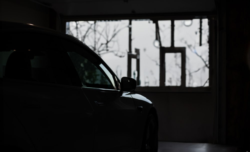 a car parked in a garage next to a window