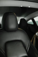 Minimalist interior dashboard with ambient lighting highlighting stitching.