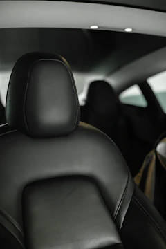Minimalist interior dashboard with ambient lighting highlighting stitching.