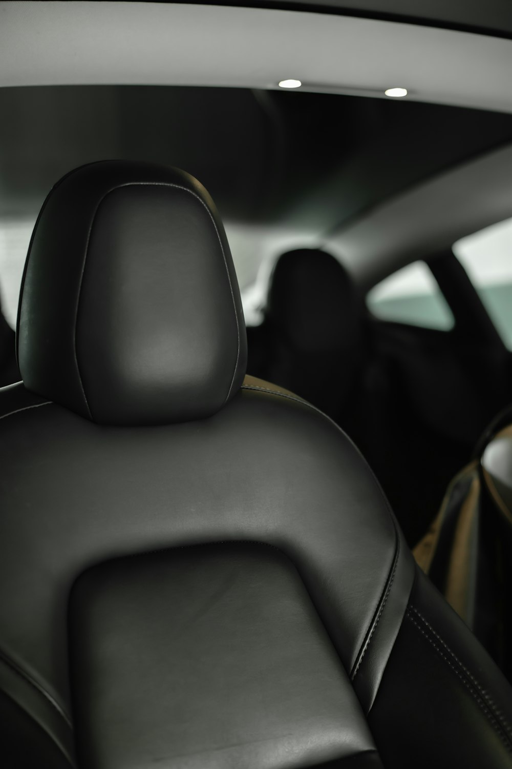 the back seats of a car with the sunroof down