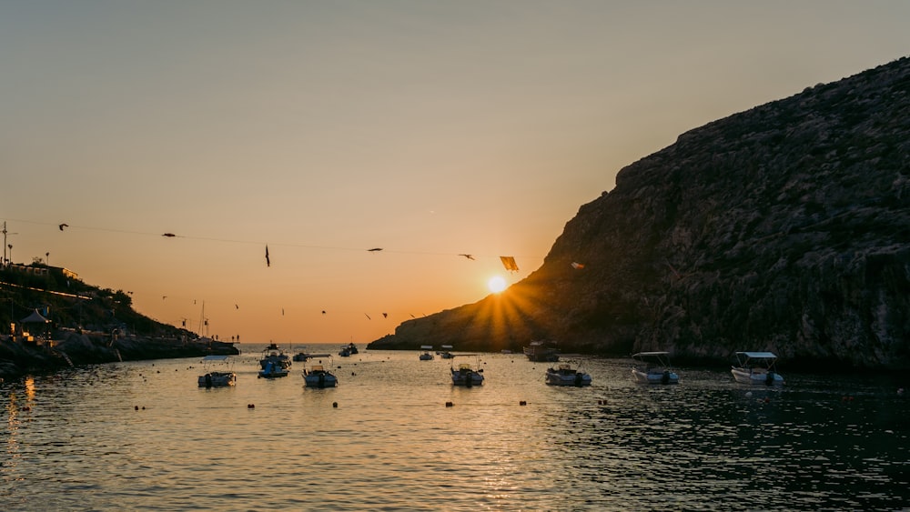 a group of boats floating on top of a body of water