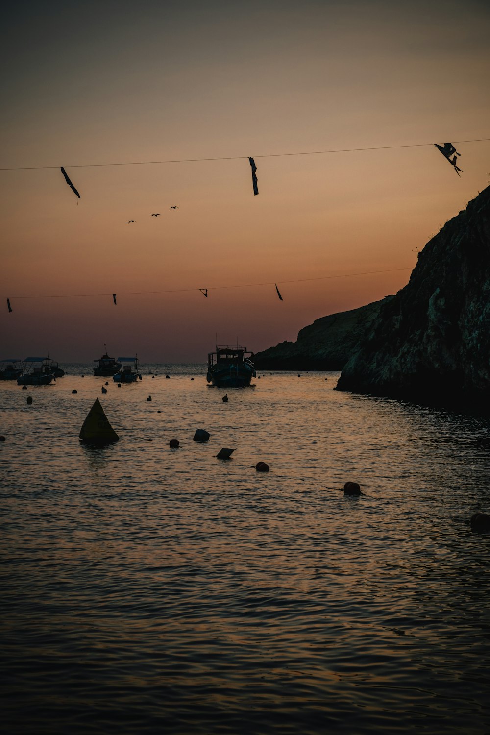 a group of boats floating on top of a body of water