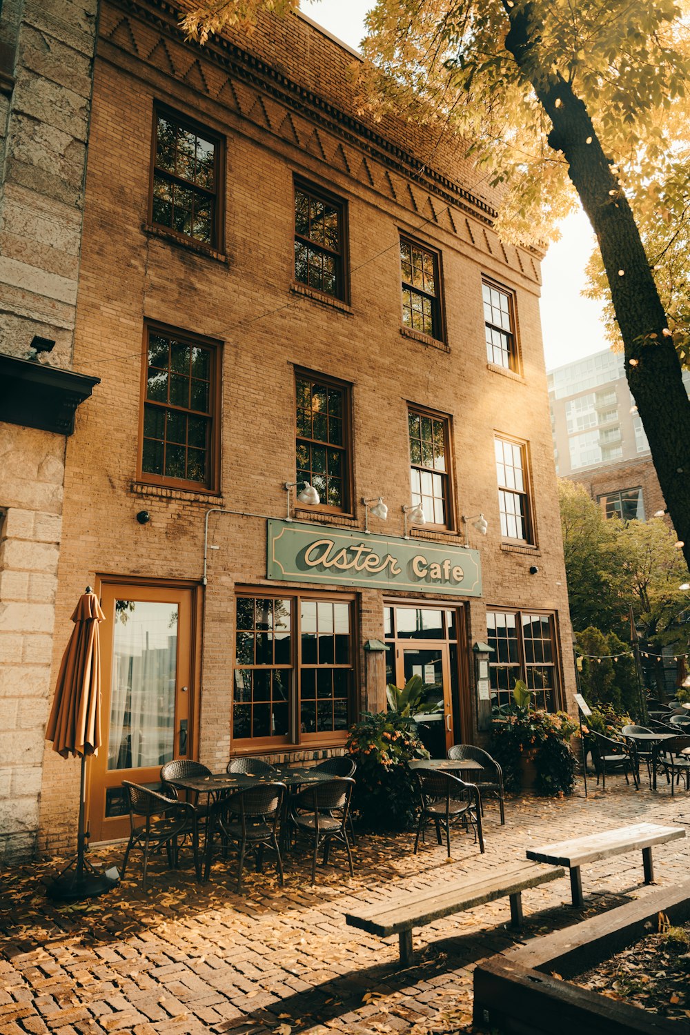 a brick building with tables and chairs in front of it