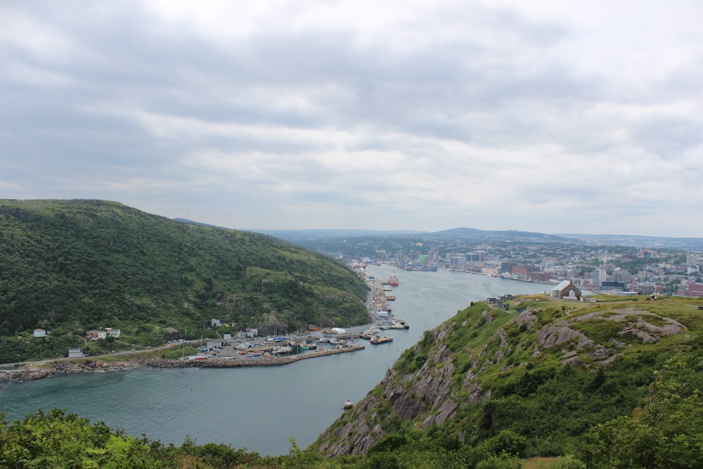 a large body of water surrounded by a lush green hillside