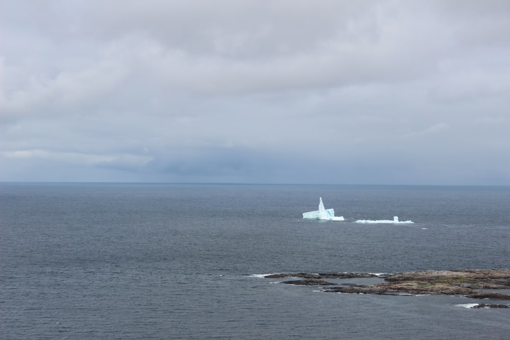 a large iceberg floating in the middle of the ocean