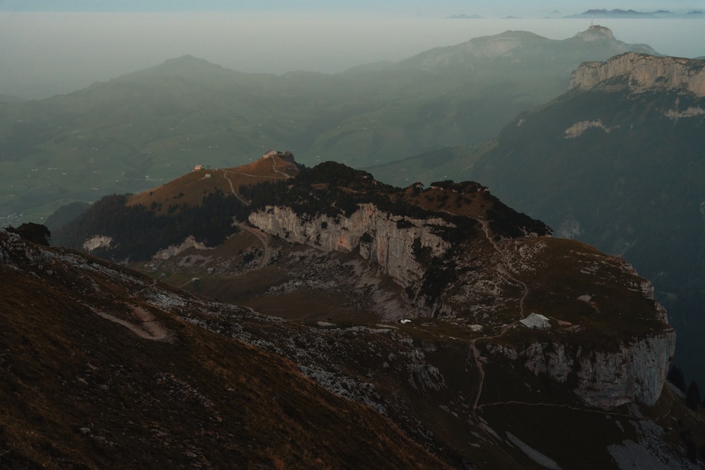 a view of a mountain range from the top of a hill