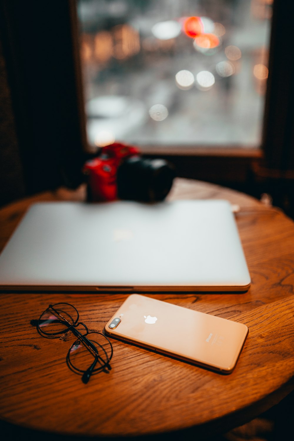 an apple laptop computer sitting on top of a wooden table