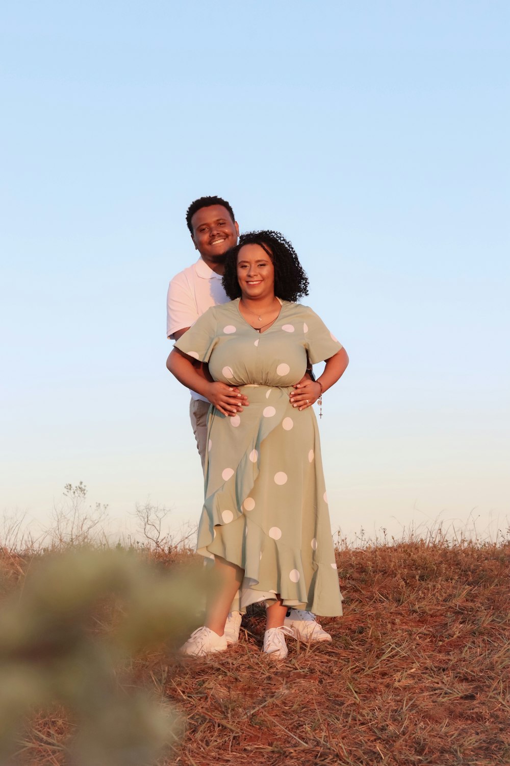 a man and a woman standing in a field