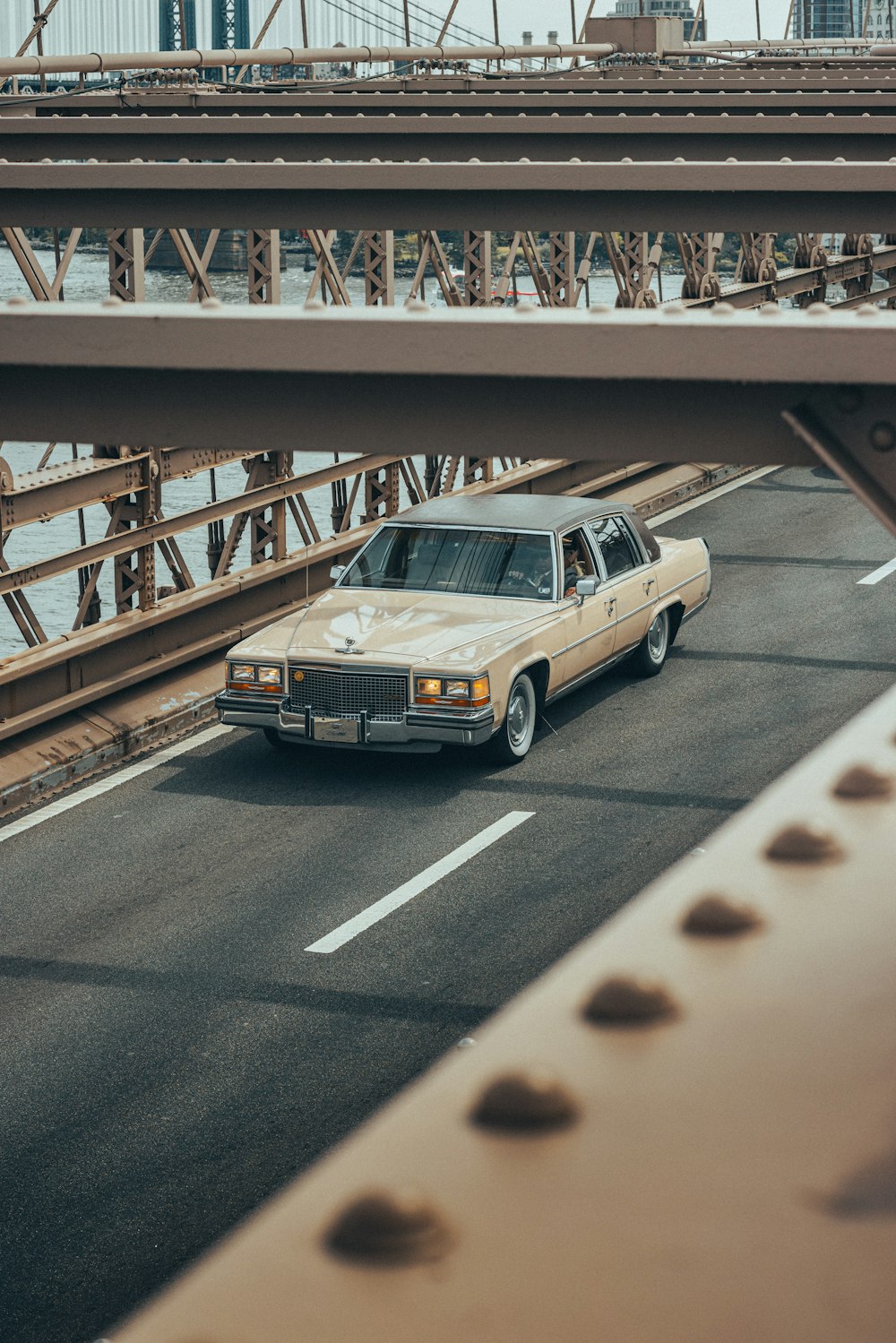 a car driving on a bridge over a body of water