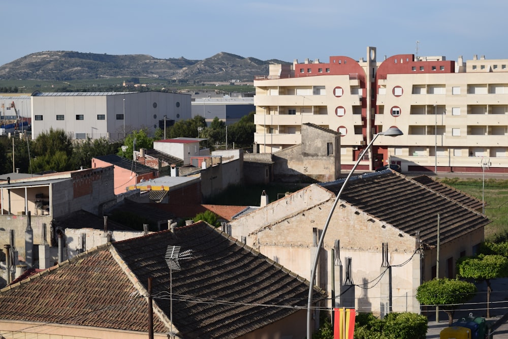 a view of a city with buildings and hills in the background