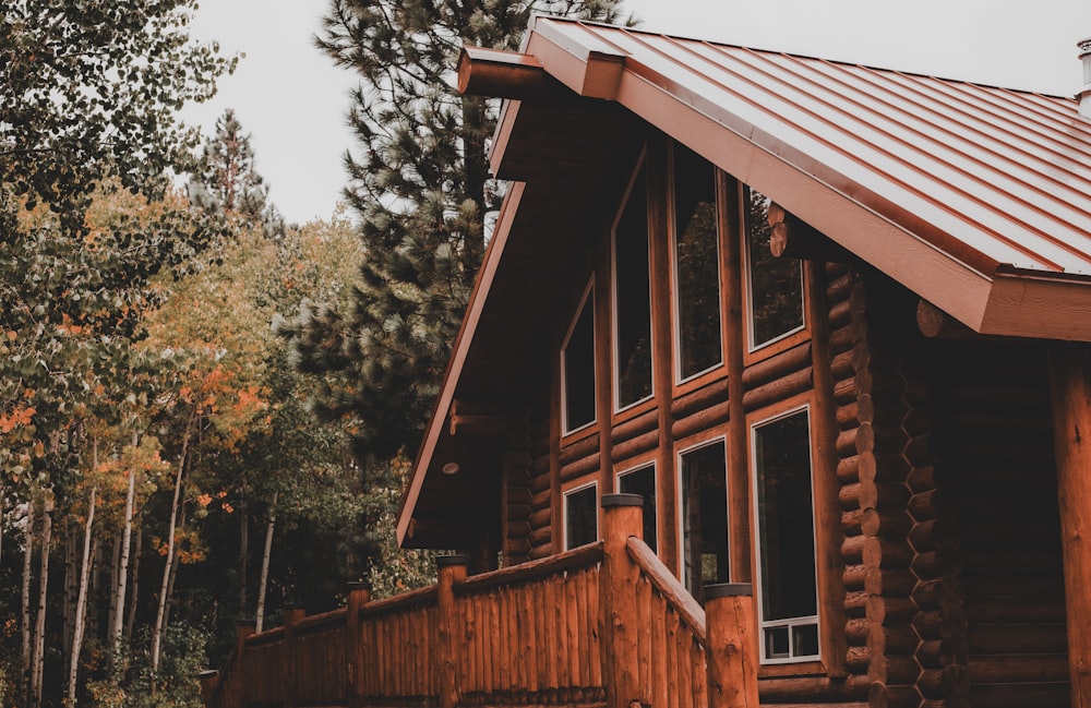 a log cabin with a metal roof and a red tin roof