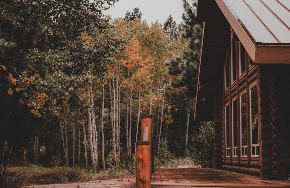 a cabin in the woods with a wooden deck