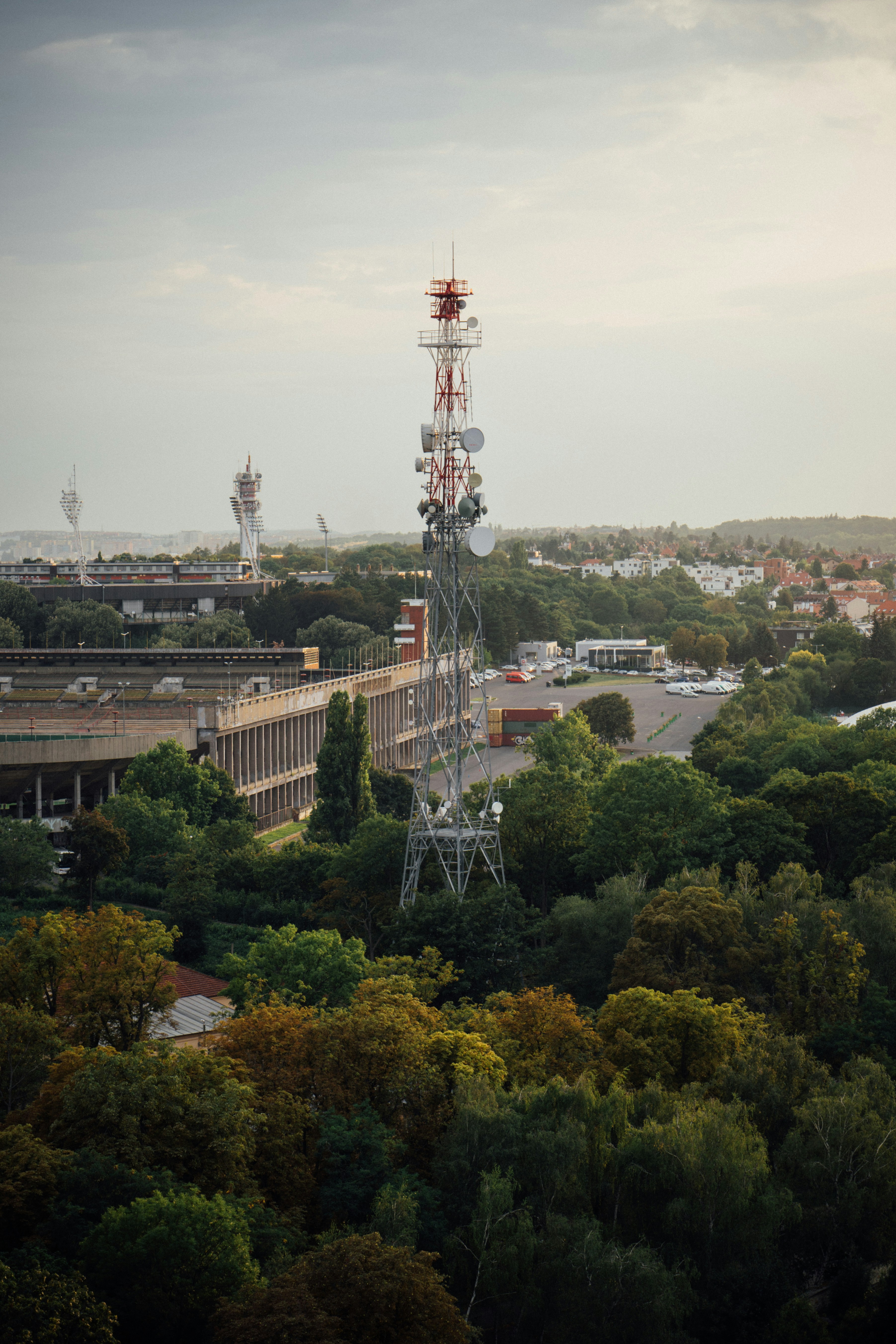 a very tall tower sitting above a lush green forest