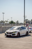 White 2019 Honda Civic gleaming under a clear Texas sky in a suburban driveway.