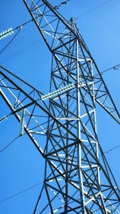 A technician installing a copper bonded electrode at an industrial site under a clear sky.