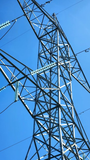 A technician installing a copper bonded electrode at an industrial site under a clear sky.