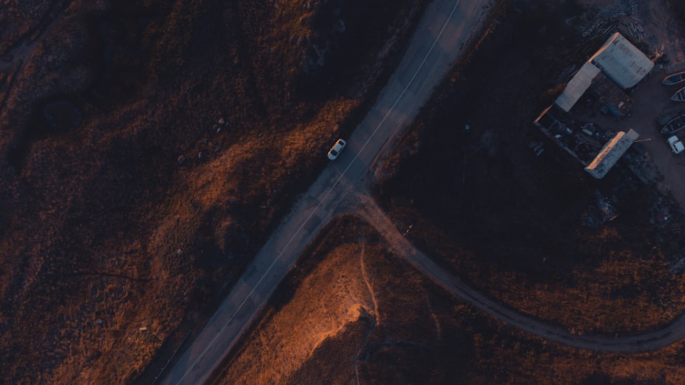 an aerial view of a road in the middle of a field