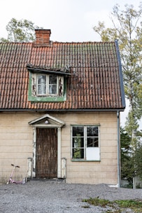 an old house with a bicycle parked in front of it