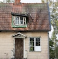 an old house with a bicycle parked in front of it