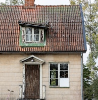 an old house with a bicycle parked in front of it