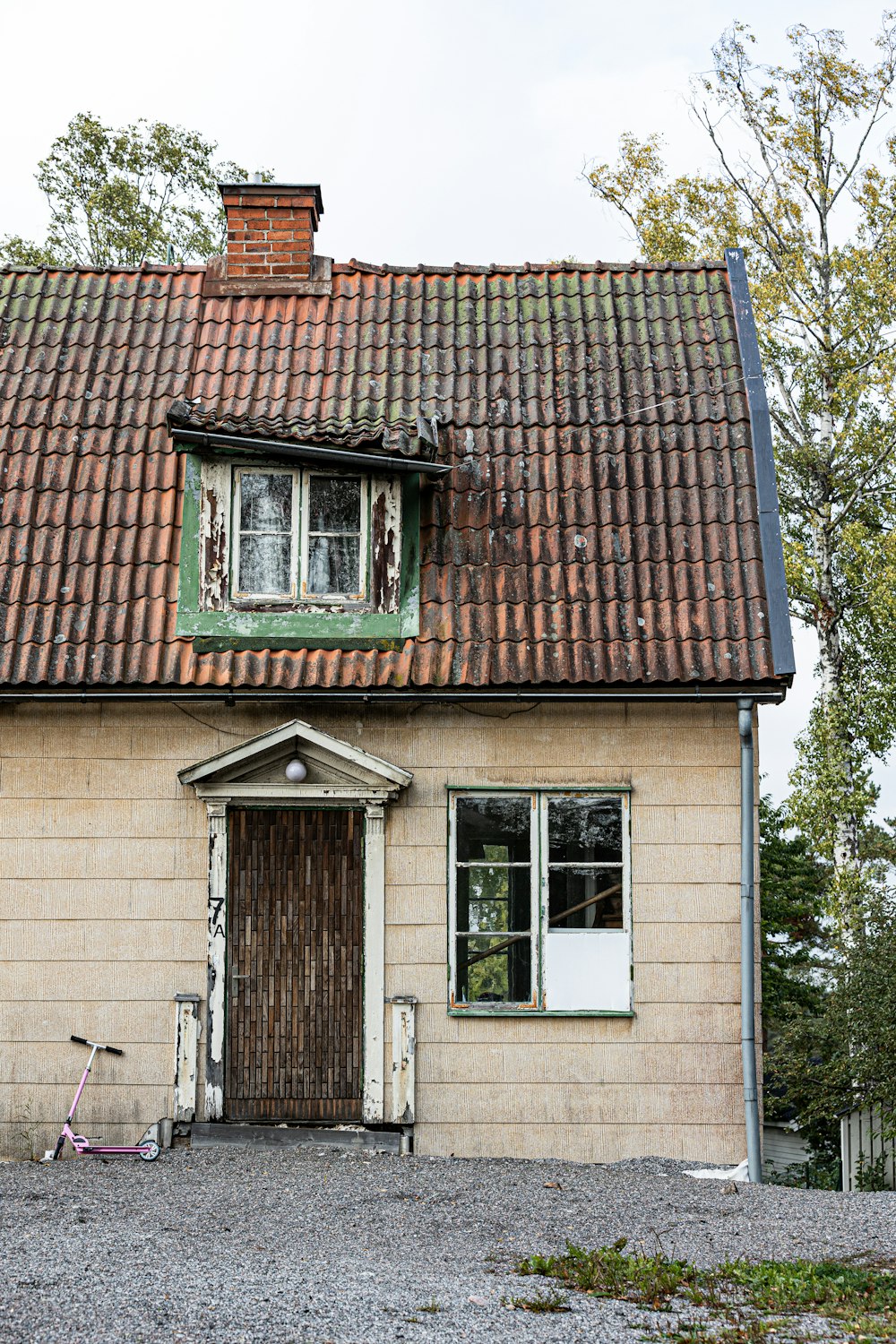 an old house with a bicycle parked in front of it