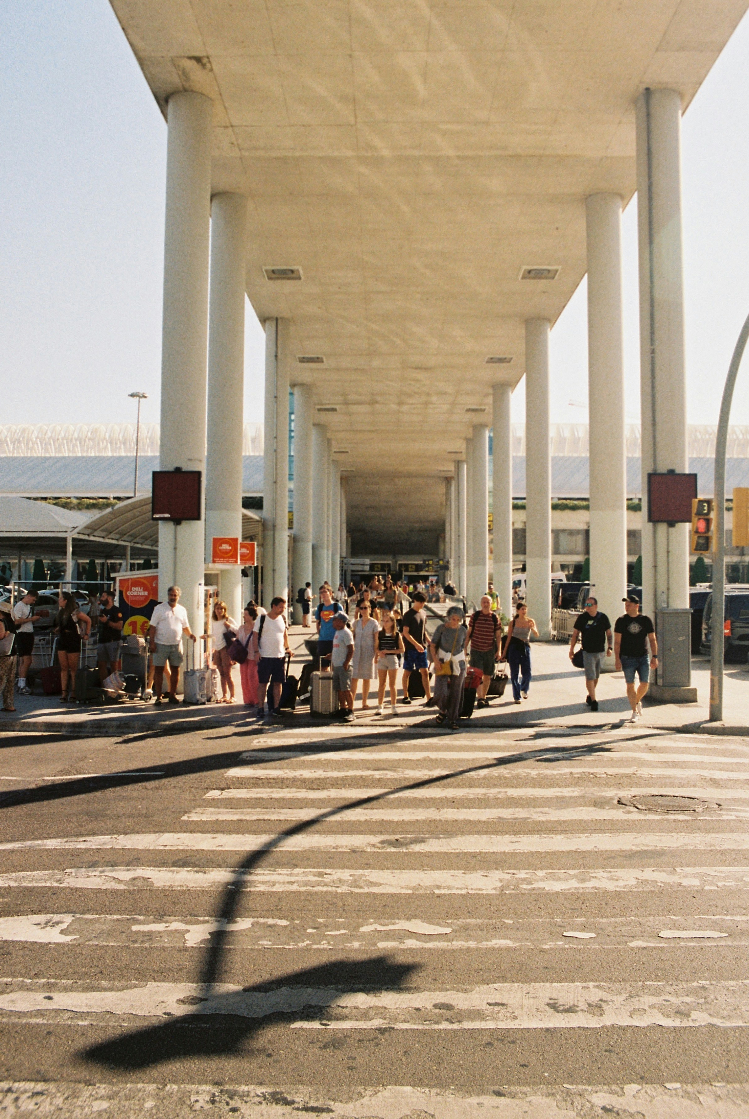 a group of people crossing a street under a bridge