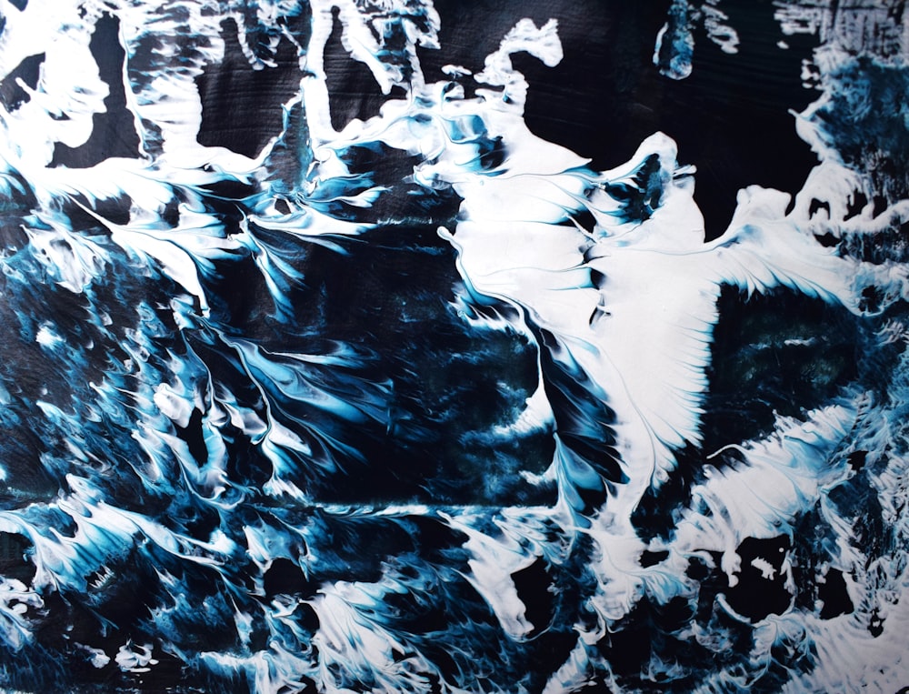 a black and white painting with blue and white swirls