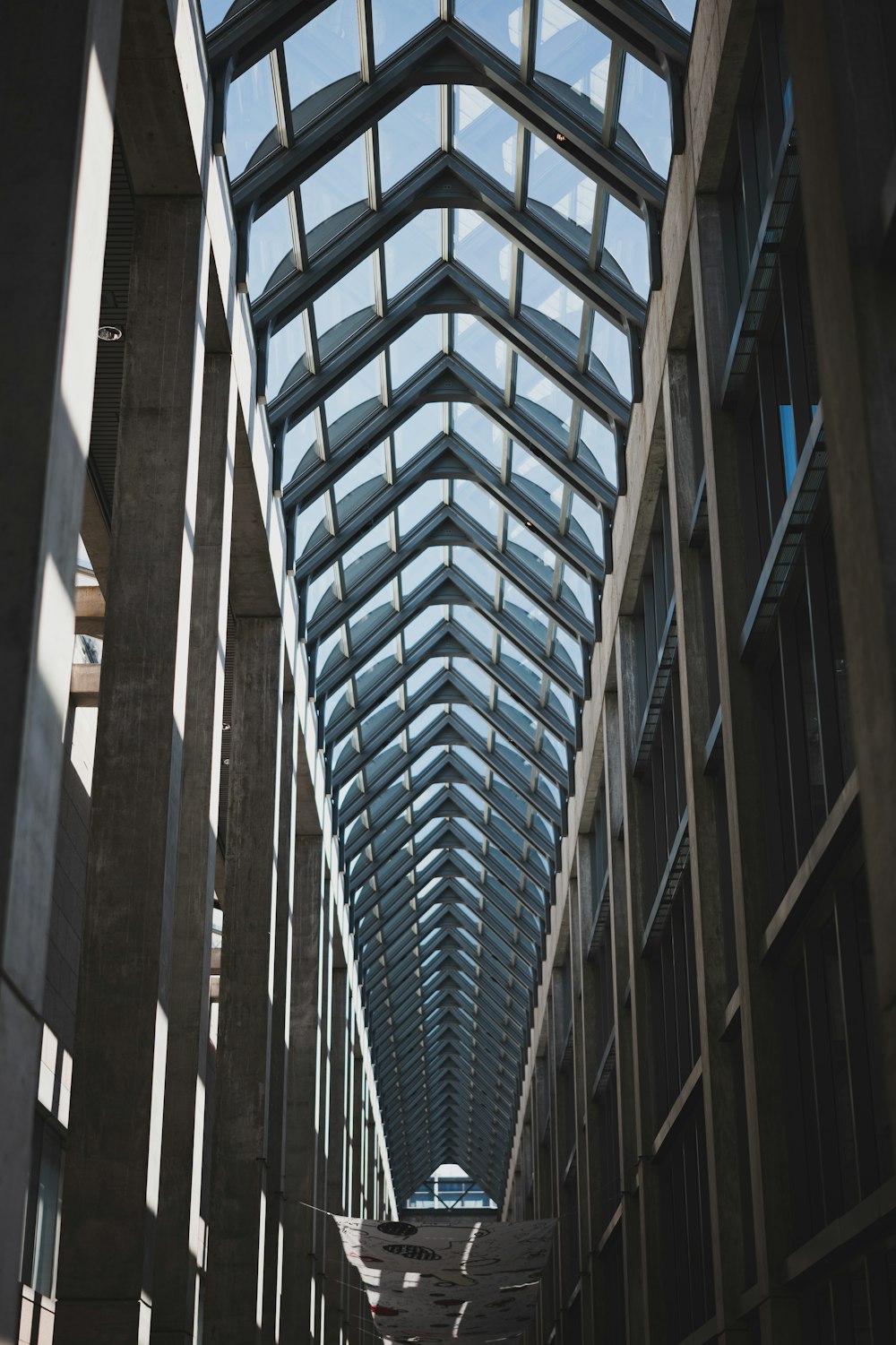 a walkway with a skylight in the middle of it