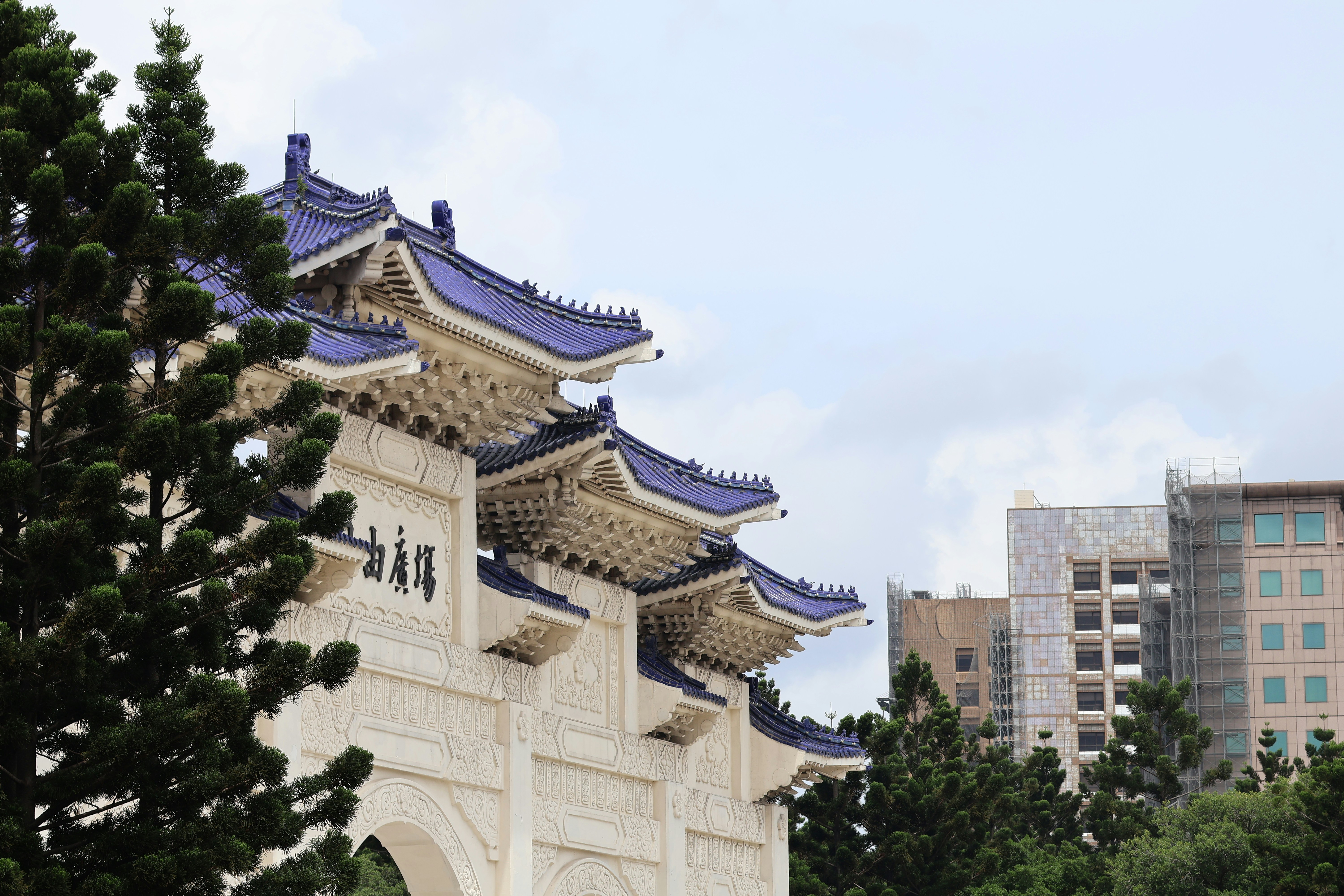 a tall white building with a blue roof