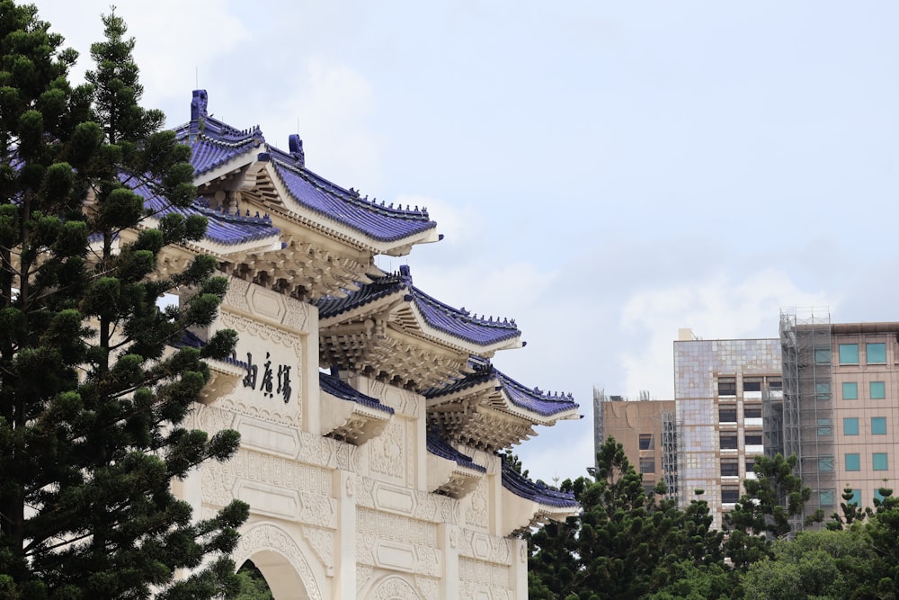 a tall white building with a blue roof