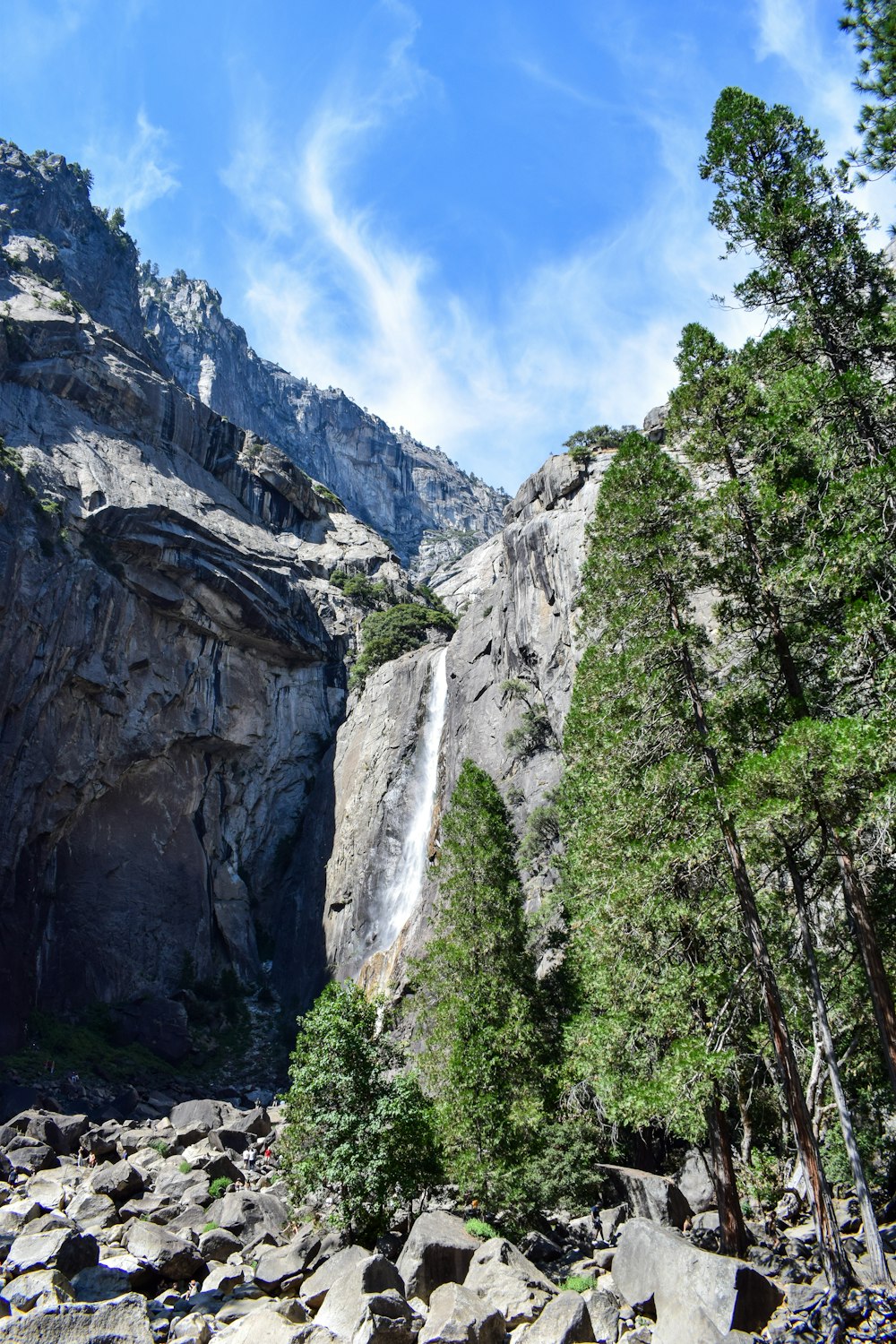 a view of a waterfall from the bottom of a mountain