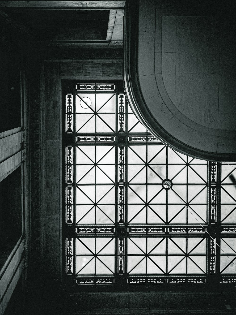 a black and white photo of a window in a building