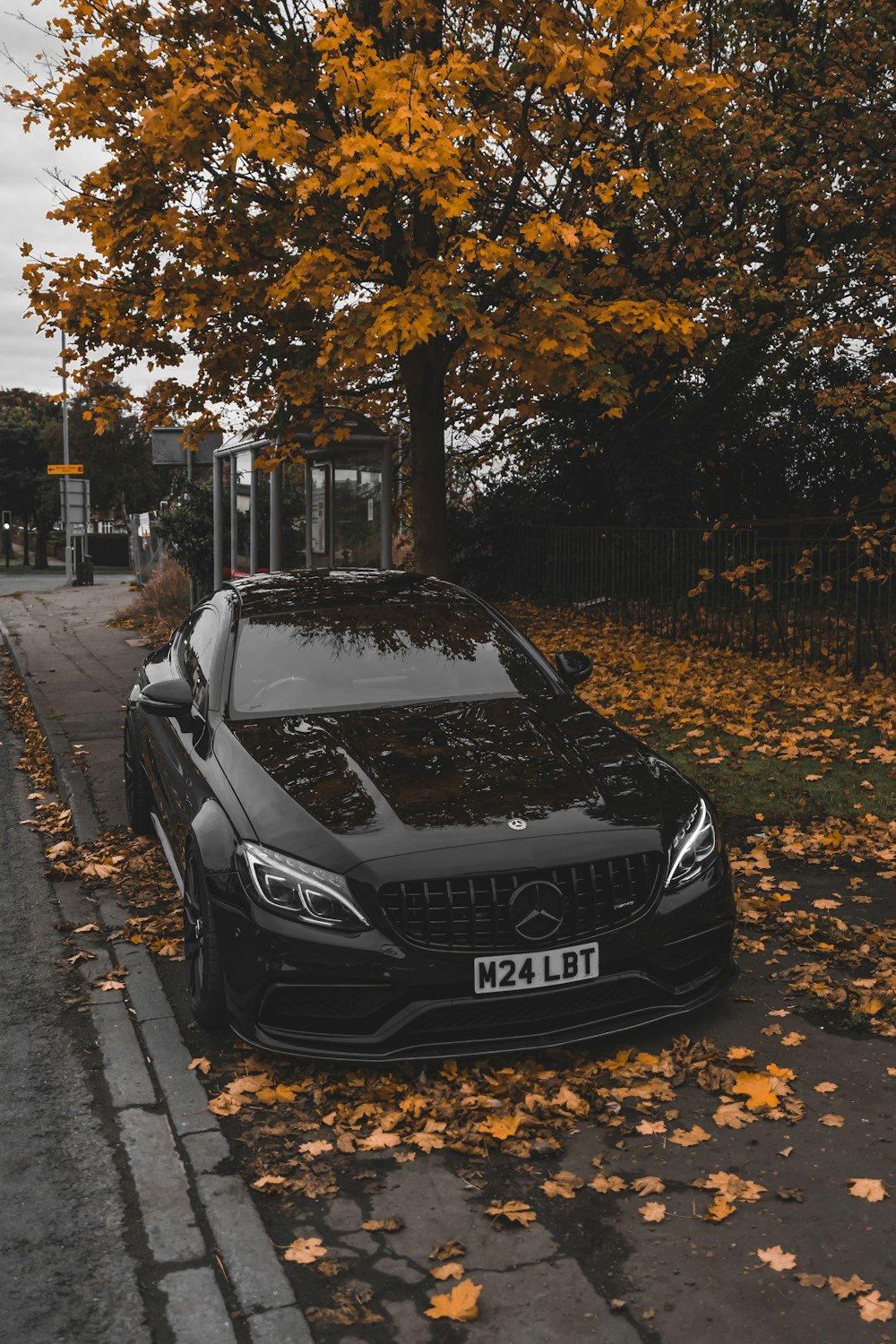 a black car parked on the side of the road