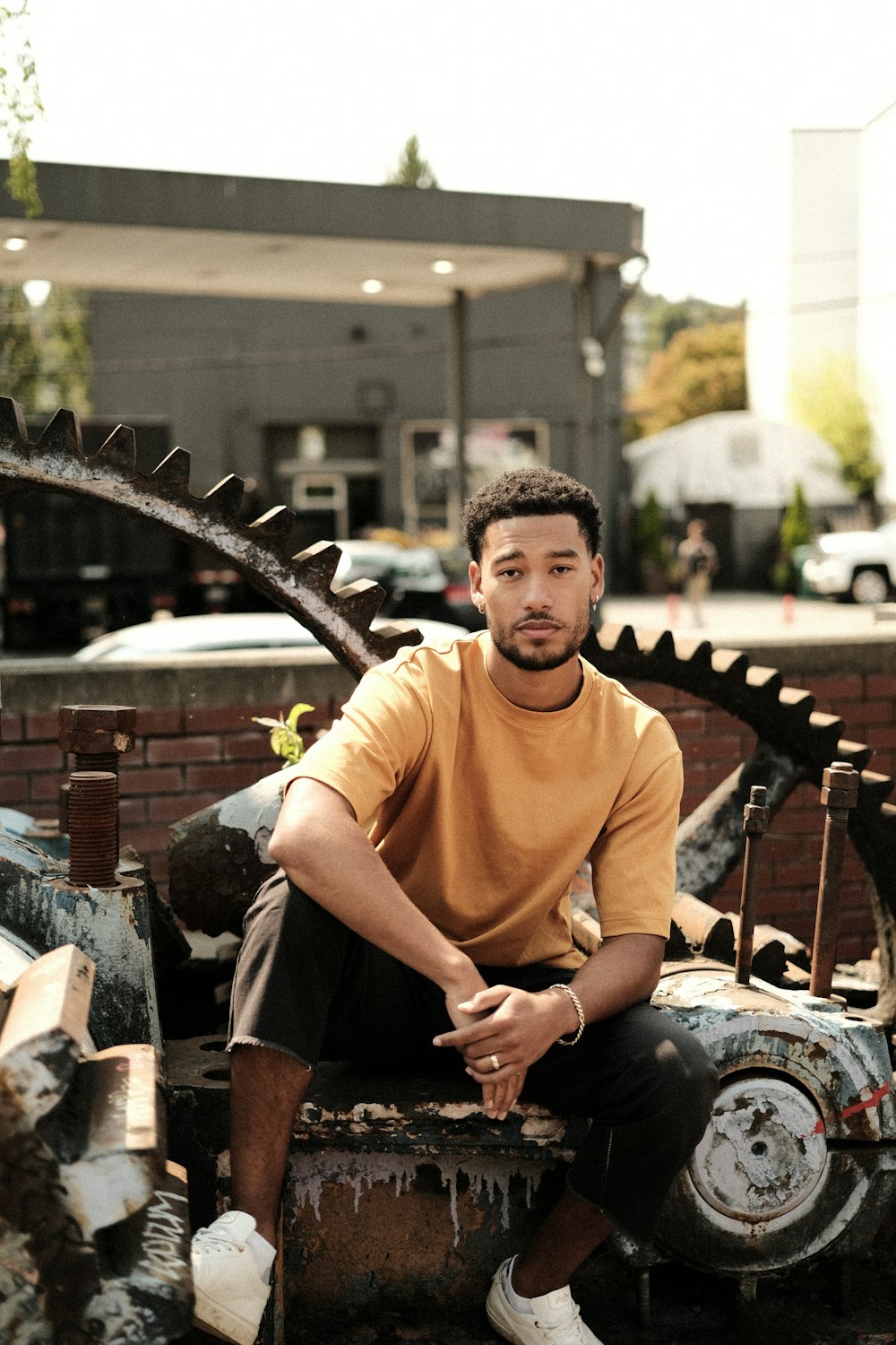 a man sitting on top of a rusted car