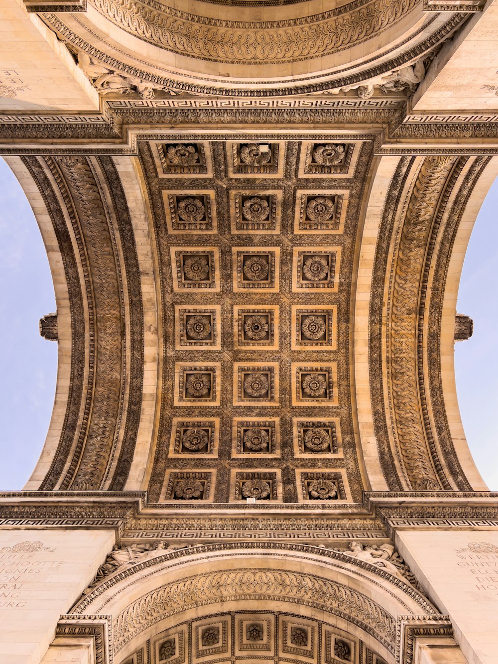 the ceiling of a building with a clock on it