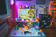 A cozy setup with a laptop streaming a live pack opening, surrounded by Pokémon memorabilia.