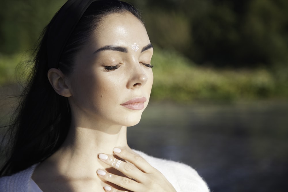 a woman with her hands on her chest