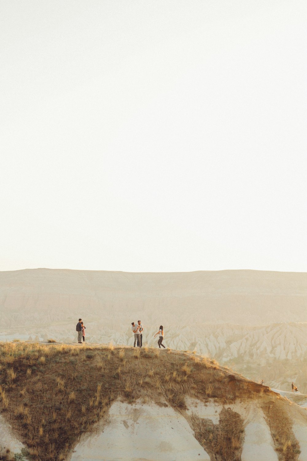 a group of people standing on top of a hill