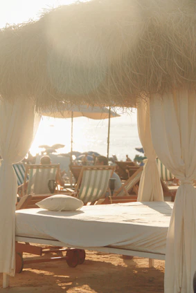A serene massage setup on a sunlit terrace overlooking Ibiza's natural landscape.
