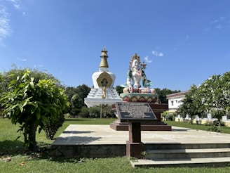 a statue of a person sitting on top of a bench