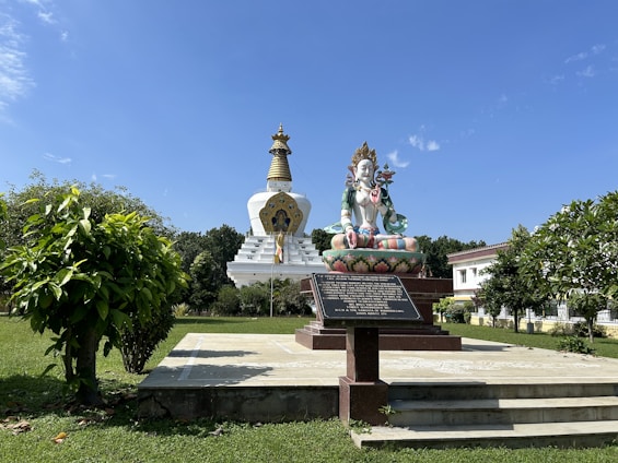a statue of a person sitting on top of a bench