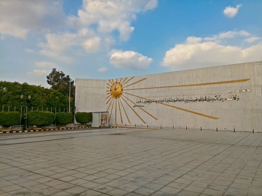 a large building with a sun on the side of it