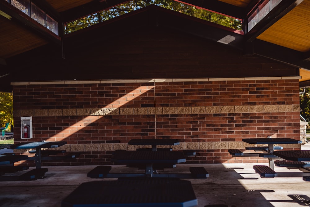 a brick building with tables and benches in front of it