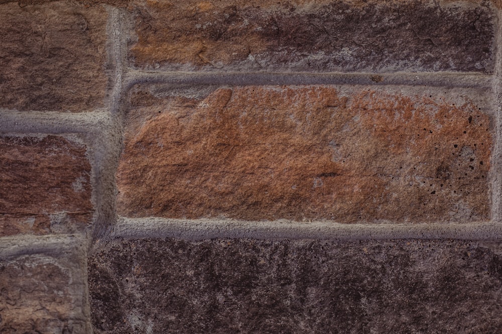 a close up of a stone wall with brown and tan colors