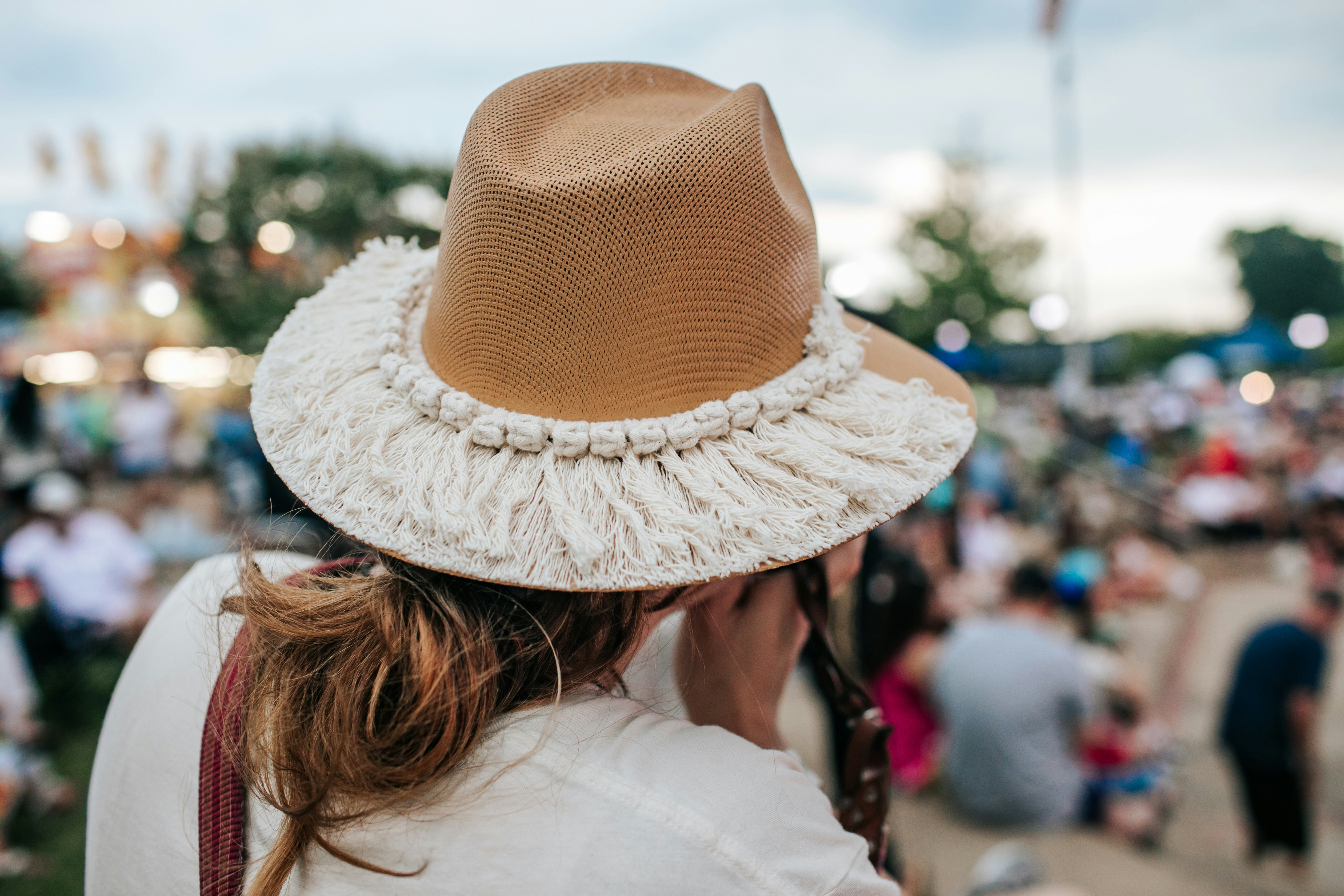a woman wearing a brown and white hat